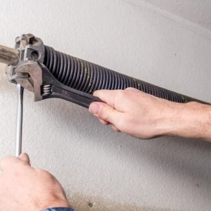 DYG Garage Doors specialist performing maintenance on a garage door spring