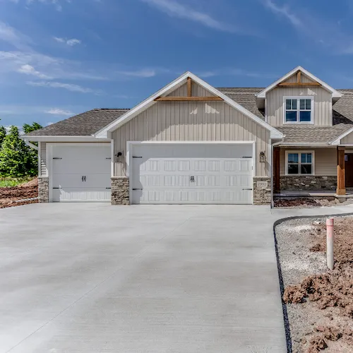 Modern suburban home with two white paneled garage doors