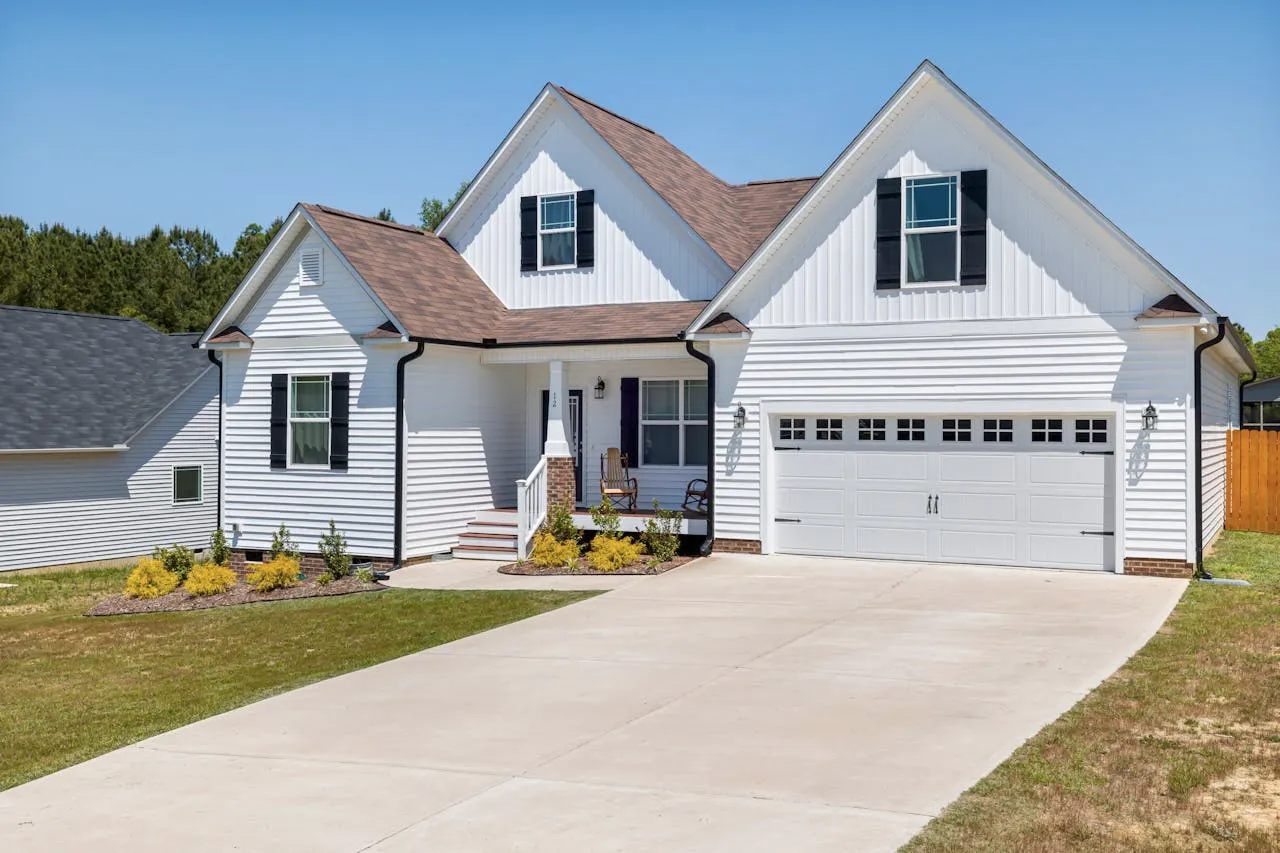 Front exterior of a newly built house showcasing a professionally installed white garage door